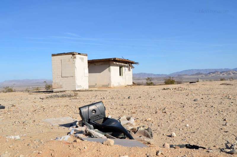 Old vacuum in front of abandoned home
